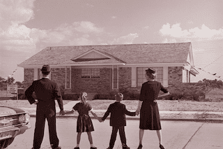fifties family in front of house